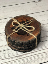 Load image into Gallery viewer, set of 4 round wildlife tracks-themed Acacia wood coasters tied with string