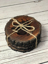 Load image into Gallery viewer, set of 4 round wildlife tracks-themed Acacia wood coasters tied with string
